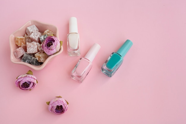 Top view beauty products arrangement with pink background