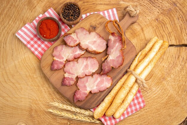 Top view becon slices on wooden serving board