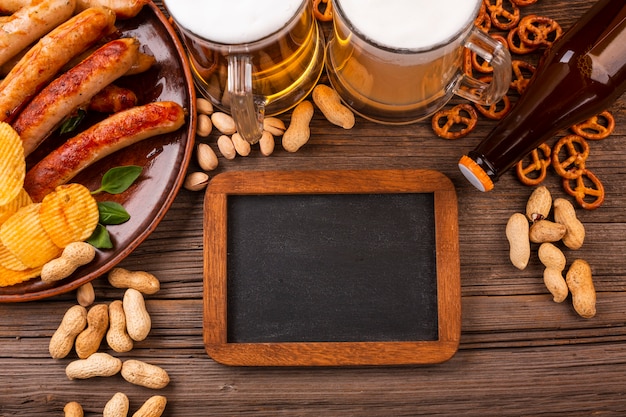 Top view beer with food on wooden table