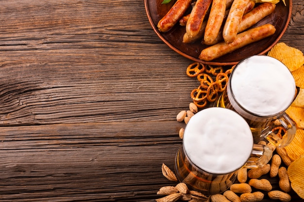 Top view beer with food on wooden table