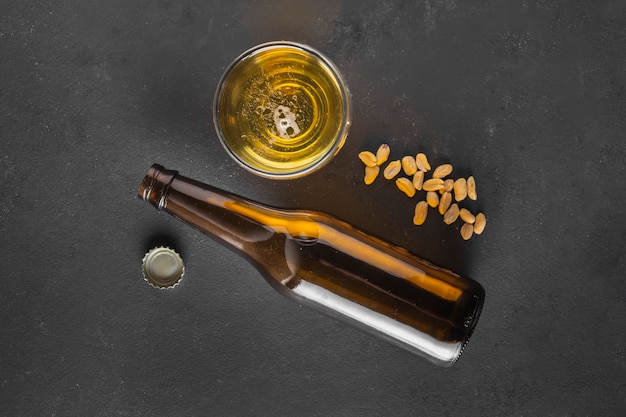 Top view beer with peanuts on table