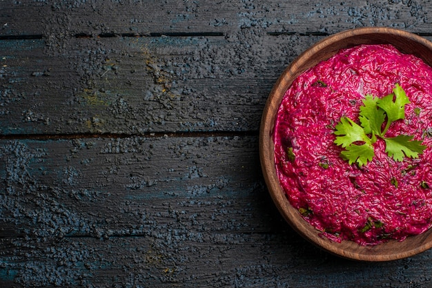 Top view beet salad with walnuts and mayyonaise on dark desk