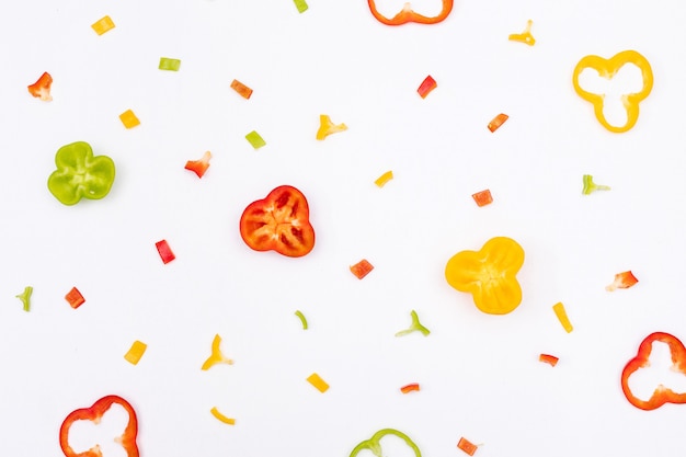 Top view bell pepper pepper sliced and chopped pattern on white  horizontal