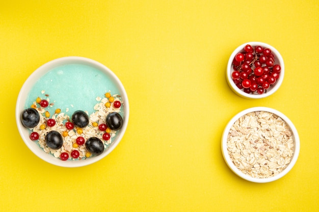 Top view berries bowls of colorful berries the appetizing oatmeal