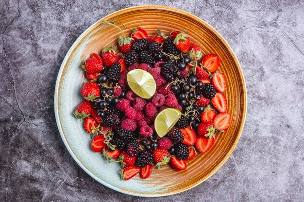 Top view of berries plate with lime