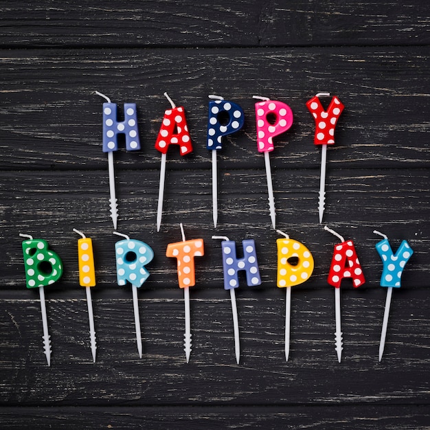 Free photo top view birthday candles on wooden background