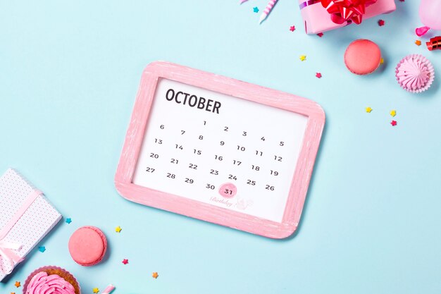 Top view birthday reminders in calendar and cupcakes