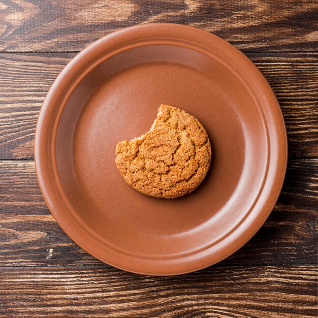 Top view bitten cookie on plate