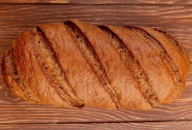 Top view of black bread on wooden table