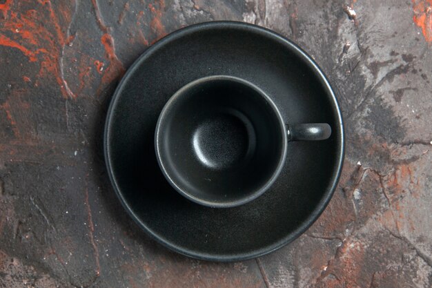 Top view black cup and saucer on dark background