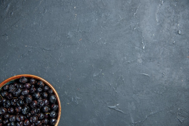 Top view black currant on dark surface free place