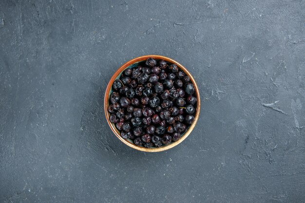 Top view black currant on dark surface free space