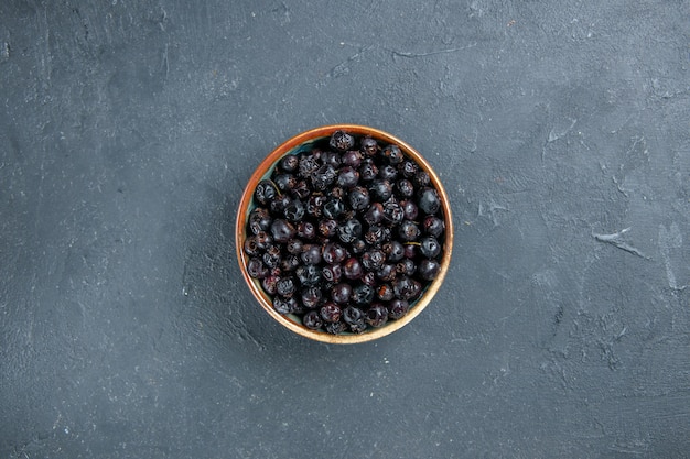 Top view black currant on dark surface free space