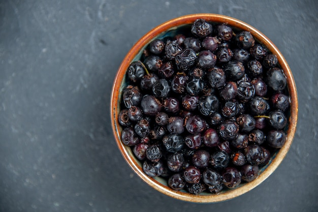 Top view black currant on dark surface