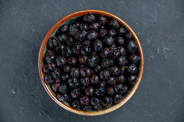 Top view black currant on dark surface