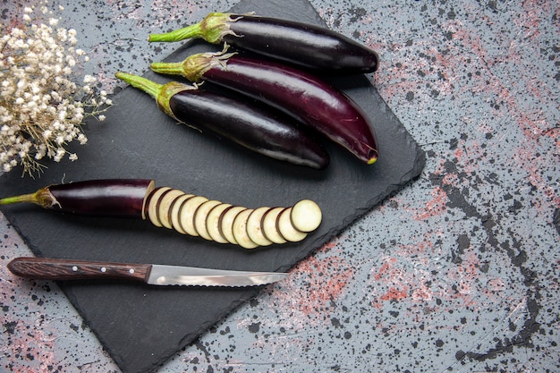 top view black eggplants on cutting board blue surface food dinner lunch salad color meal tree grow ripe young