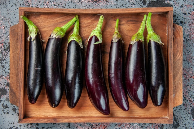 top view black eggplants inside cutting board on light surface food color ripe meal fresh salad vegetable dinner