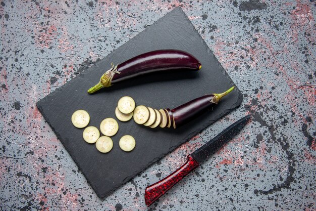 top view black eggplants sliced and whole on cutting board blue surface grow food dinner lunch salad tree ripe young color meal