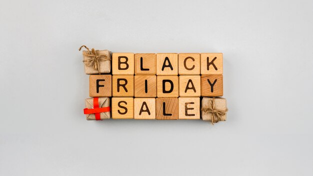 Top view of black friday cubes on plain background