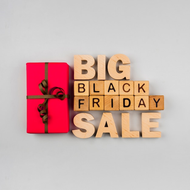 Top view of black friday cubes and present on plain background