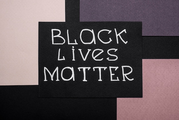 Top view of black lives matter card on multicolored paper