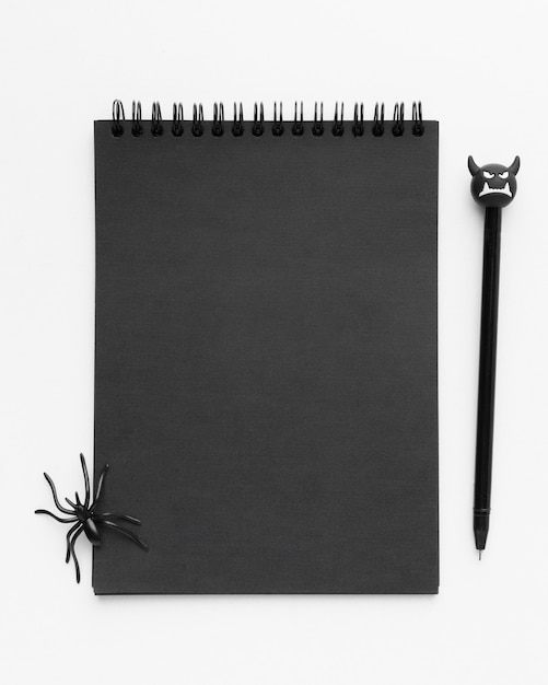 Top view black notepad with spider on top