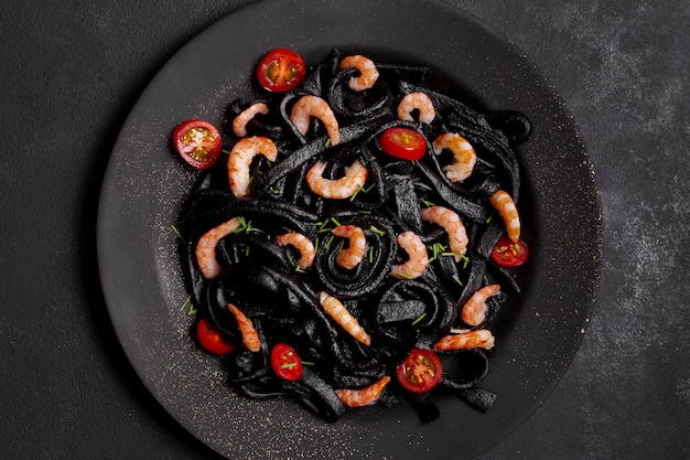 Top view black shrimp pasta arrangement on plate