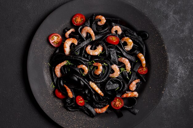 Top view black shrimp pasta arrangement on plate