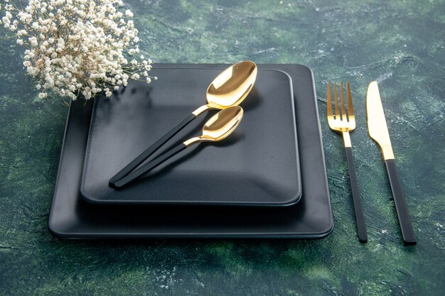 top view black square plates with golden fork spoons and knife on dark surface color food cutlery dinner restaurant