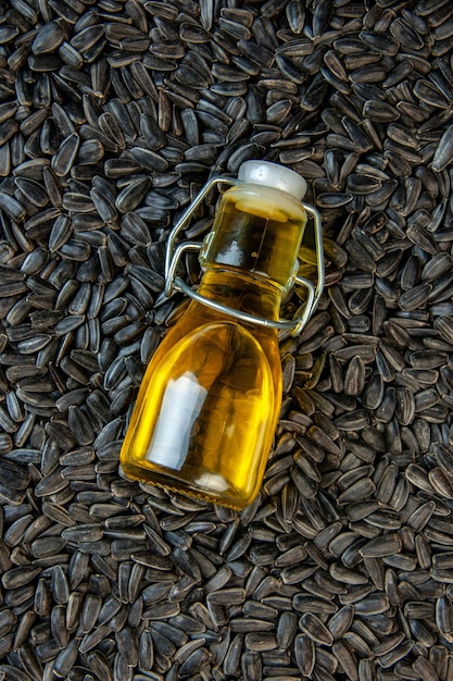 Free photo top view black sunflower seeds with oil on dark background corn snack oil color cips seed photo