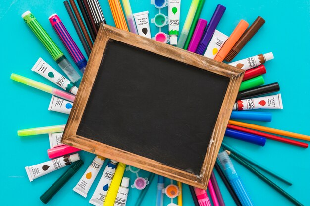 Top view blackboard surrounded by painting elements