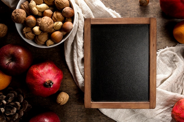 Top view of blackboard with autumn fruits and nuts