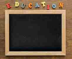 Free photo top view of blackboard with letters