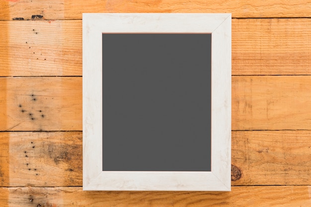 Top view blank board on wooden floor
