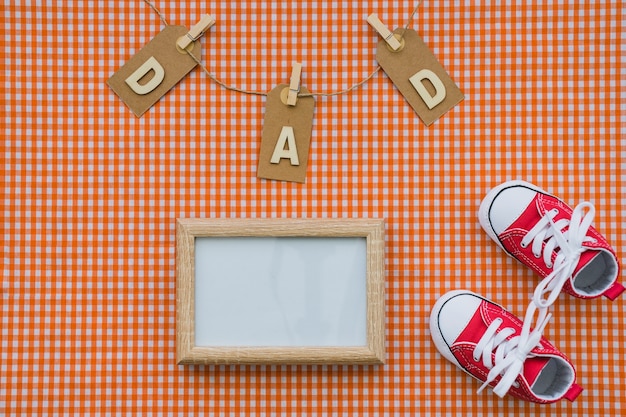 Top view of blank frame and shoes for father's day