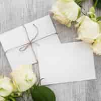 Free photo top view of blank greeting card; roses and wooden plank