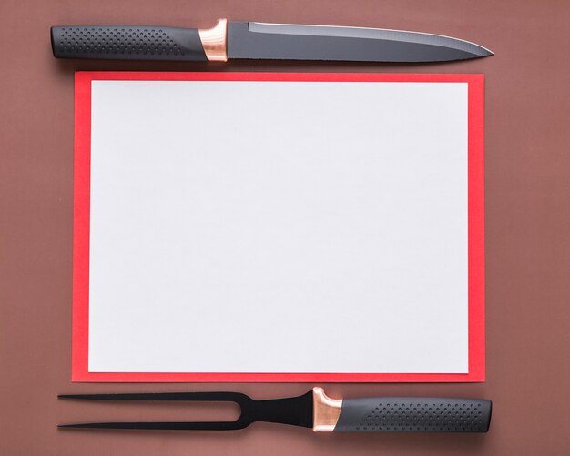 Top view of blank menu paper with knife and fork