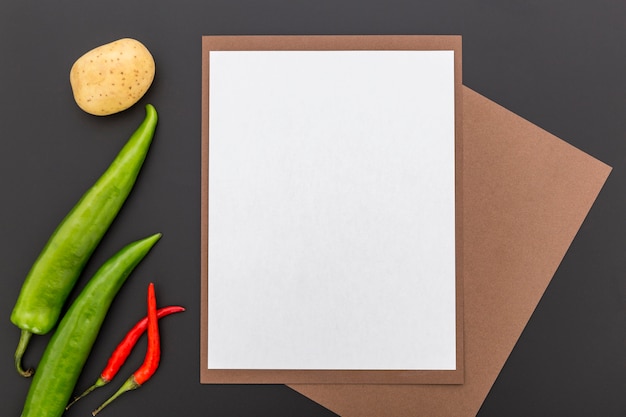 Top view of blank menu paper with peppers and potato