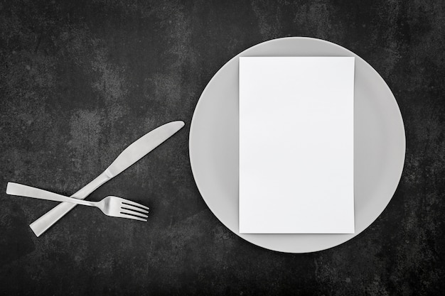 Free photo top view of blank menu paper with plate and cutlery