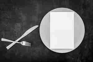 Free photo top view of blank menu paper with plate and cutlery