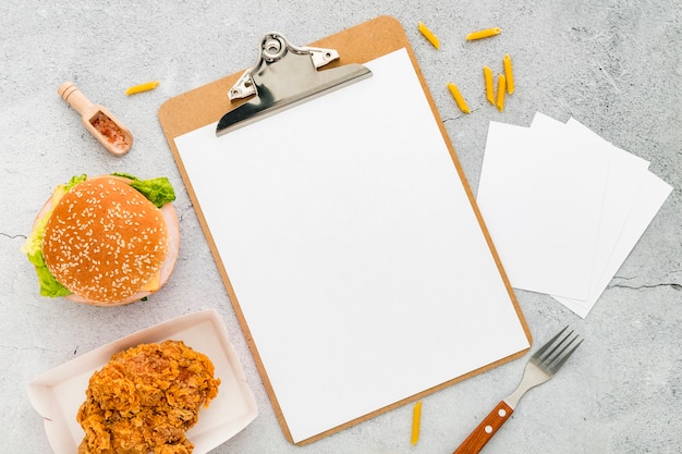 Top view of blank menu with burger and fried chicken