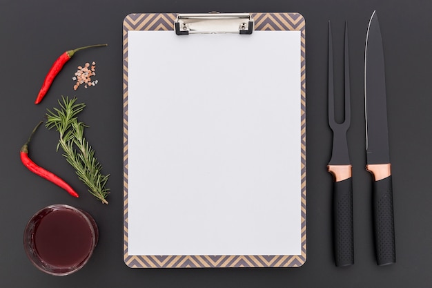 Top view of blank menu with chili pepper and cutlery