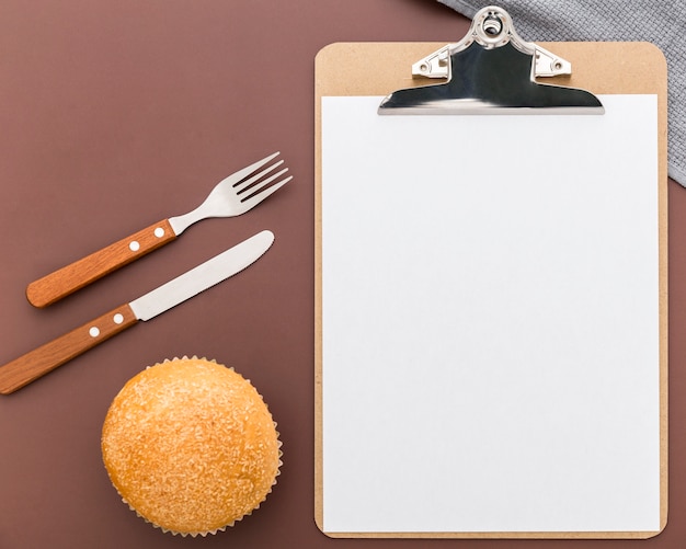 Top view of blank menu with cutlery and bun