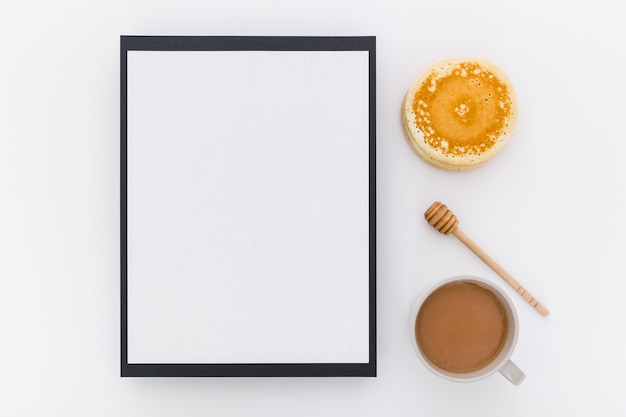 Top view of blank menu with pancakes and honey