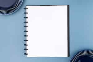 Free photo top view of blank notebook menu with plates