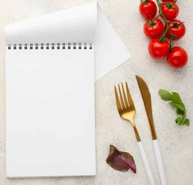 Top view blank notepad with tomatoes
