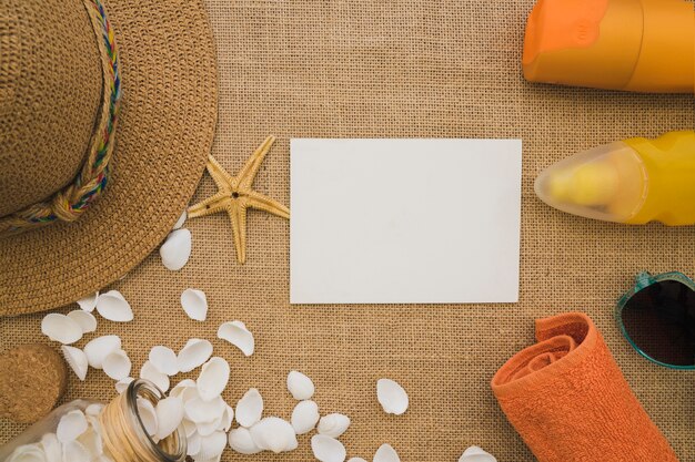 Top view of blank paper with variety of summer elements