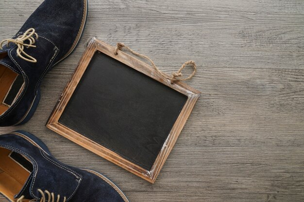 Top view of blank slate and shoes for father's day