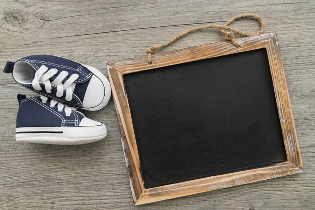 Top view of blank slate with decorative shoes