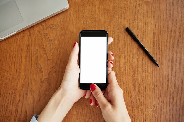 Top view of blank white smartphone screen